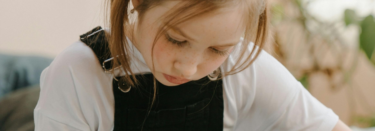young girl writing in a notebook