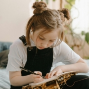 young girl writing in a notebook
